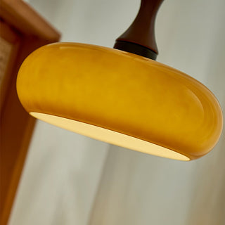 Yellow dome pendant showing wooden accent detail