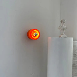 Circular glass wall sconce E27 in orange 14cm – front view