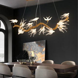 Gold sculptural branch pendant detail — bird motif ceiling fixture