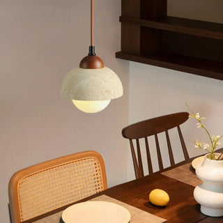Amber glass wood pendant light illuminated — warm travertine ceiling lamp