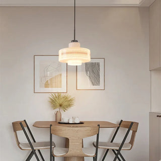 Cream cylindrical pendant light in living room setting, soft vintage hanging ceiling lamp