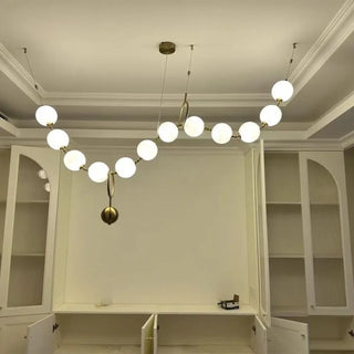 Designer gold globe pendant, modern ceiling light with soft ambient glow