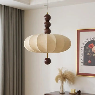 Designer hanging lamp, fabric shade with wooden details, soft ambient lighting