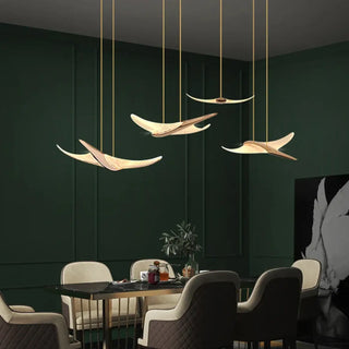 Sculptural gold LED pendant light with aerial scroll design, modern luxury ceiling fixture