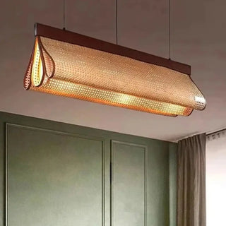 Rattan linear pendant illuminated — warm natural ambient ceiling fixture