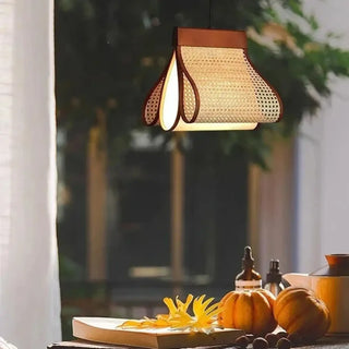 Rattan linear lamp over dining table — organic warm ambient pendant
