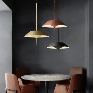 Gold pendant lamp illuminated in dining room — elegant metal ceiling fixture