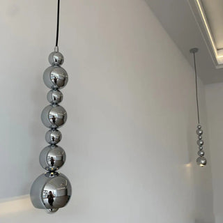 Designer totem pendant light close-up, modern sculptural hanging ceiling lamp