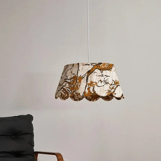 Embroidered gold motif pendant light close-up, decorative fabric hanging ceiling lamp