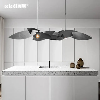 Modern metal leaf pendant light close-up, sculptural warm ambient hanging ceiling lamp