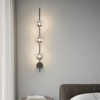 Gold 3-light wall sconce L 100cm installed in stairwell